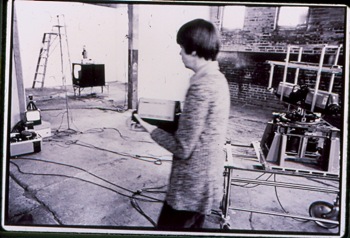 Media artist Steina installing ALLVISION: An Electro/Opto/Mechanical Environment, in the Backspace at Hallwalls, 1976.